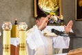 Christian priest standing by the altar