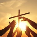 Christian religious concept. Silhouette Hands touching reaching for cross at sunset with glow and ray of the sun Royalty Free Stock Photo