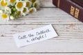 Christian Sabbath rest handwritten note with closed holy bible and flowers on wooden table