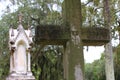 Christian Stone Cross and Spanish Moss Trees in Cemetery Royalty Free Stock Photo