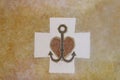 Christian symbol: anchor, heart, cross on a yellow background. Marble slab with ornament or mosaic. The decoration of religious