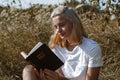 Christian teenage girl reading the Bible in the field. Faith, spirituality and religion concept Royalty Free Stock Photo