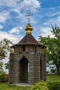 A Christian temple made of a wooden frame with a golden dome and a cross. Royalty Free Stock Photo