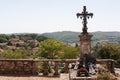 A christian tombstone with crosses on it in front of a southern French landscape