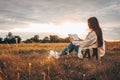 Christian woman holds bible in her hands. Reading the Holy Bible in a field during beautiful sunset. Concept for faith, Royalty Free Stock Photo