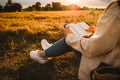 Christian woman holds bible in her hands. Reading the Holy Bible in a field during beautiful sunset. Concept for faith, Royalty Free Stock Photo