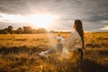 Christian woman holds bible in her hands. Reading the Holy Bible in a field during beautiful sunset. Concept for faith, Royalty Free Stock Photo