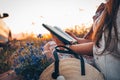 Christian woman holds bible in her hands. Reading the Holy Bible in a field during beautiful sunset. Concept for faith, Royalty Free Stock Photo