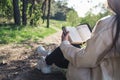 Christian woman holds bible in her hands. Reading the Bible in nature. Concept for faith, spirituality and religion Royalty Free Stock Photo