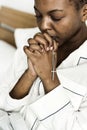 A Christian woman praying in bed Royalty Free Stock Photo