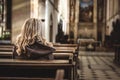 Christian woman is praying in church. Religion and spirituality concept