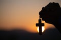 Christian woman praying on holy cross in the morning, teenager woman hand with cross praying,Hands folded in prayer in church Royalty Free Stock Photo