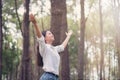 Christian worship with raised hand in pine forest,Happy woman de Royalty Free Stock Photo