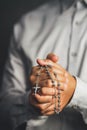 Christianity background of man hand holding rosary praying for god blessing Royalty Free Stock Photo