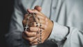 Christianity background of man hand holding rosary praying for god blessing Royalty Free Stock Photo