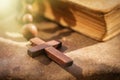 Christianity, religion, faith concept. Rosary cross against Bible background as a symbol of victory over death.. Selective focus Royalty Free Stock Photo