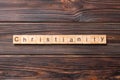 Christianity word written on wood block. christianity text on table, concept