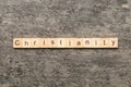 christianity word written on wood block. christianity text on table, concept