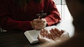 Christians are congregants join hands to pray and seek the blessings of God on the wooden table Royalty Free Stock Photo