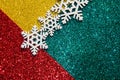 Christmas abstract background. Bokeh lights. Shiny sparkle metallic glitter texture. White decorative snowflake on red, green, Royalty Free Stock Photo