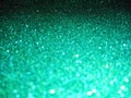 Christmas abstract background. Defocused lights texture. Abstract bokeh lights. Shiny sparkle emerald metallic glitter texture.