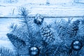 Christmas accessories in blue and fir branches on wooden background in classic blue trendy color of the year 2020