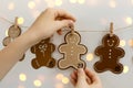Christmas Advent calendar with hands taking the task. Figures in the form of smiling gingerman cookies. Concept DIY