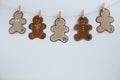 Christmas Advent calendar. Hanging on a rope, figures in the form of smiling gingerman cookies. Concept Christmas, DIY