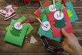 Christmas Advent calendar on the table, in a wooden box. Multicolored envelopes made by hand