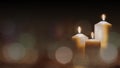Christmas advent candle light in church with blurry golden bokeh for religious ritual or spiritual zen meditation, peaceful mind