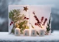 Christmas, advent wreath with four white burning candles decorated with metal numbers and two ice lanterns behind.