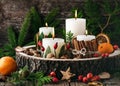 Christmas or advent wreath with four white burning candles decorated with natural material. Royalty Free Stock Photo