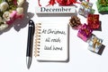 At Christmas all roads lead home written on notepad with christmas decorations background Royalty Free Stock Photo