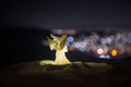 christmas angel on blur bokeh city lights at night on background. Little white guardian angel in snow Royalty Free Stock Photo