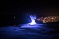 christmas angel on blur bokeh city lights at night on background. Little white guardian angel in snow Royalty Free Stock Photo