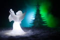 Christmas Angel glass xmas figure and glass fir tree, christmas tree, docorative elements on dark background. Christmas decoration Royalty Free Stock Photo