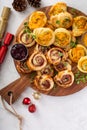 Christmas appetizers, puff pastry wheels filled with cheese and jam