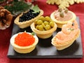 Christmas appetizers. Small tartlets with caviar and pate.