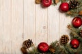 Christmas apples and spruce branches with cones on white wooden