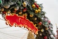 Christmas arch decorated with baubles and snow. Red signboard with word in Russian Prague. Moscow Seasons Project