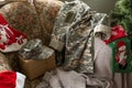 Christmas in the army. ball and gift box, military uniform, closeup view Royalty Free Stock Photo