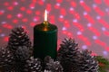 Christmas arrangement with a candle and pine cones on greenery Royalty Free Stock Photo