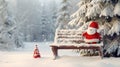 Santa hat on a bench in the snow against the background of the Christmas winter forest Royalty Free Stock Photo