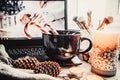 Laptop and a large cup with candys on a white wooden background with christmas toys