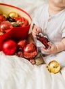 Close-up Christmas Baby in Santa Hat, Child holding christmas bauble near Present Gift Box over Holiday Lights Royalty Free Stock Photo