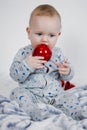 Christmas Baby in Santa Hat, Child holding Red Ball Royalty Free Stock Photo