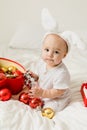 Christmas Baby in Santa Hat Child playing with baubles. Present Gift Box over Holiday Lights background and Merry Royalty Free Stock Photo