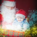 Christmas baby and Santa opening a present or gift box Royalty Free Stock Photo