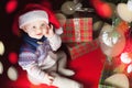 Christmas baby sitting near christmas tree and gift box! Royalty Free Stock Photo