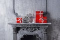 Christmas background concept. Ancient fireplace with a candlestick and gift boxes. Royalty Free Stock Photo